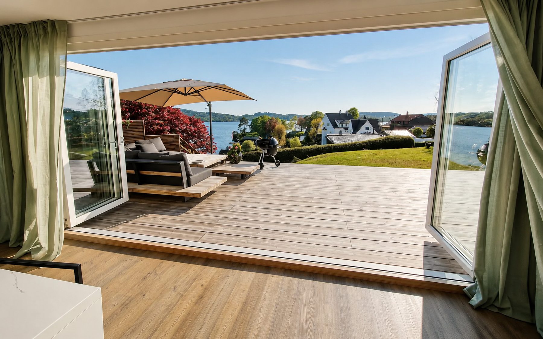 Open doors from the living room onto the deck with water views, Villa Troldhaugen